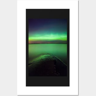 Northern lights glow over lake Posters and Art